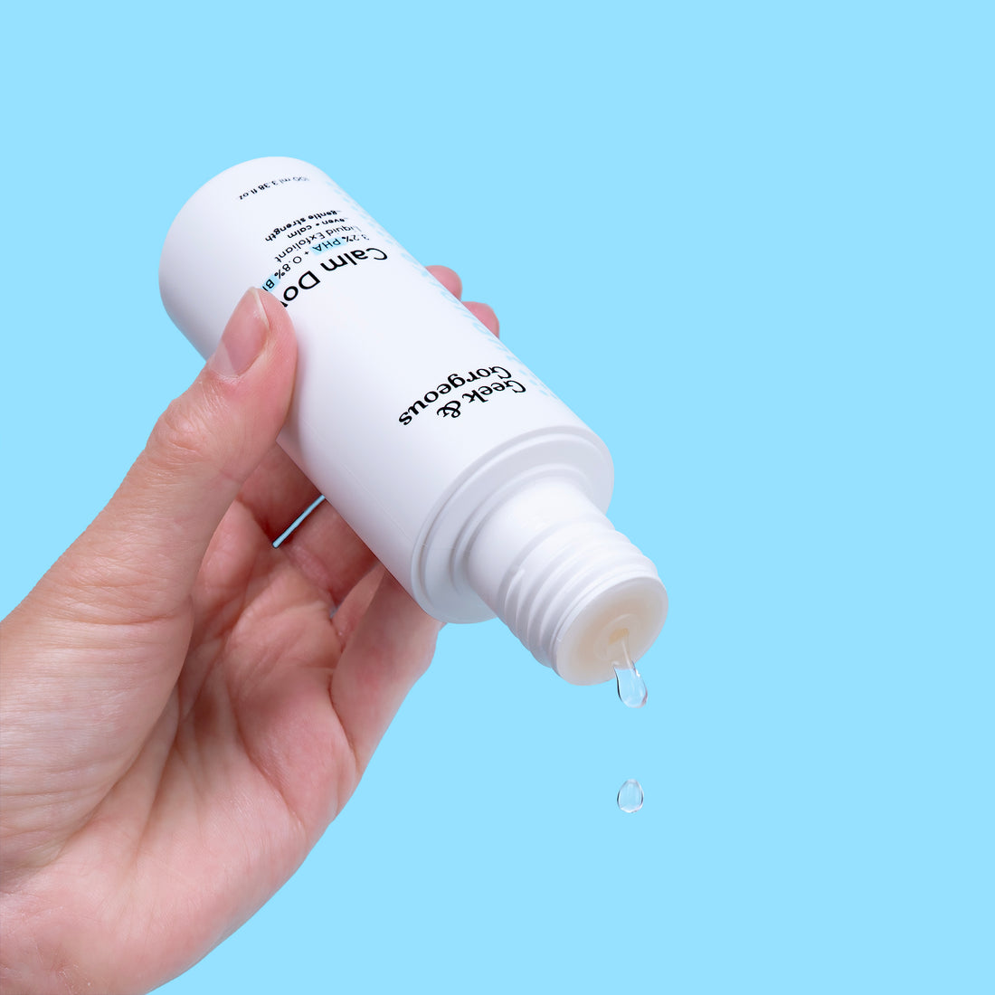 A bottle of full-sized Calm Down exfoliator on white background.