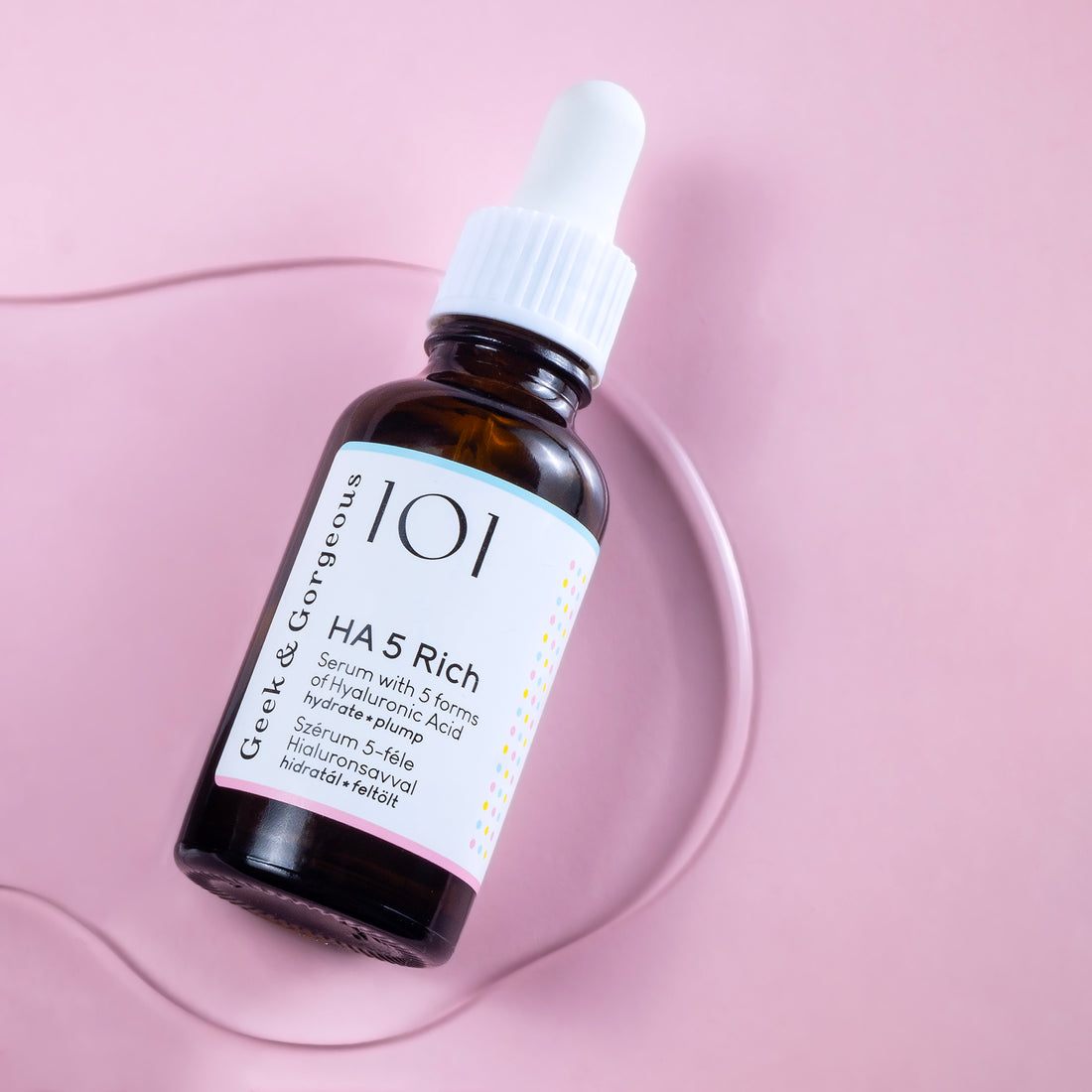 A bottle of HA5 Rich serum on white background. The bottle is made out of glass, and has a pipette with a rubber head.